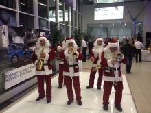 Выступление духового оркестр в костюмах Санта-клаусов в дилерском центре BMW