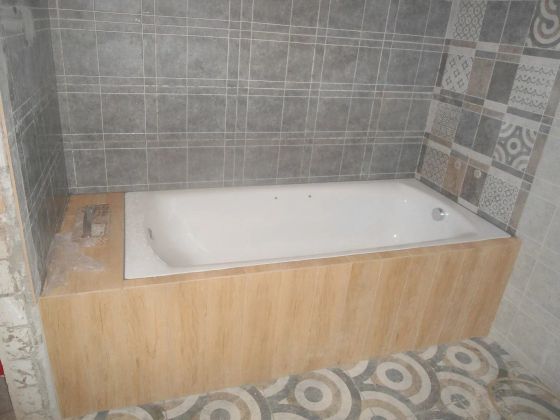 Облицовка стен керамической плиткой, установка ванны,монтаж коробов из ГКВЛ, облицовка короба керамогранитом с запилом под 45 градусов.
