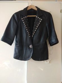 Короткий пиджак из мягкой глянцевой кожи,инкрустирован металлической модной фурнитурой.
