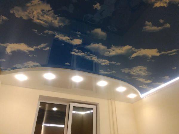 Двухуровневый натяжной потолок. Основа – небо-глянец с диодной подсветкой, подиум – белый глянец с точечными светильниками