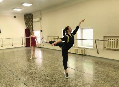 Балетная поза: грациозная танцовщица в зале репетиции